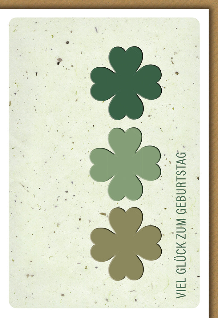 Geburtstagskarte Elegant: Drei Kleeblätter in Grün-Tönen auf Naturpapier mit Glückwunsch