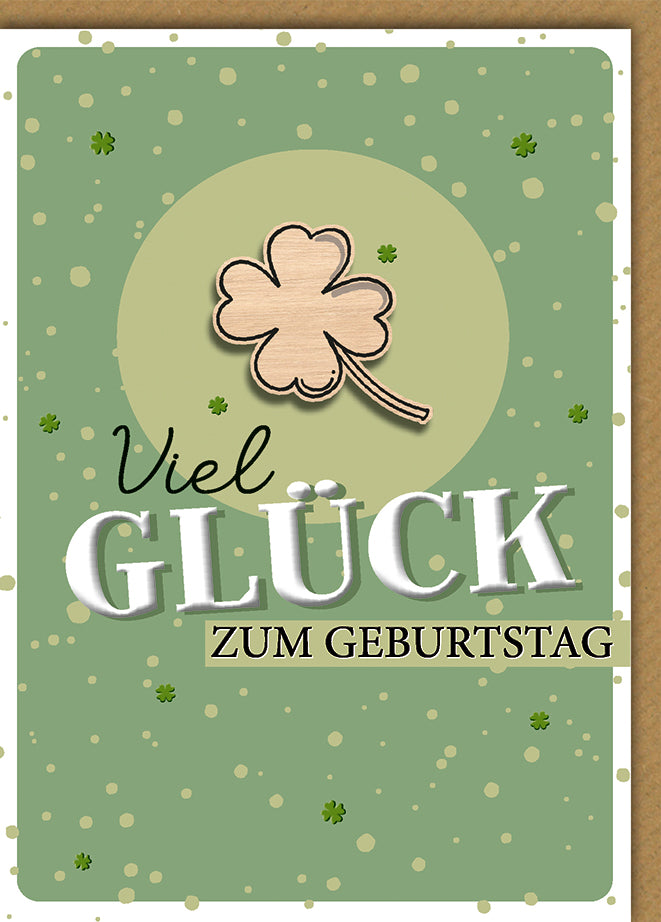 Geburtstagskarte Glücksklee: Holz-Kleeblatt auf grünem Grund mit Punktmuster