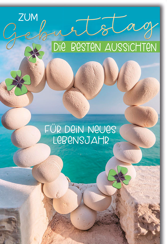 Geburtstagskarte Steinherz: Gestapelte Steine am Meer mit Kleeblättern, türkis-blau